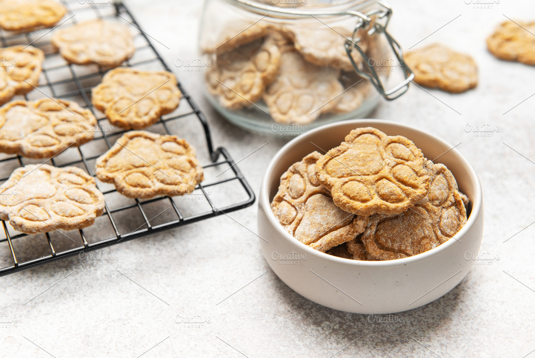 Homemade dog treats in paw print shape cooling and stored, a Food & Drink Photo by Olena Rudo