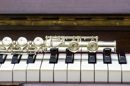 Closeup flute on the keyboard containing acoustic, boehm, and brass, an Arts & Entertainment Photo by Tzido Gallery
