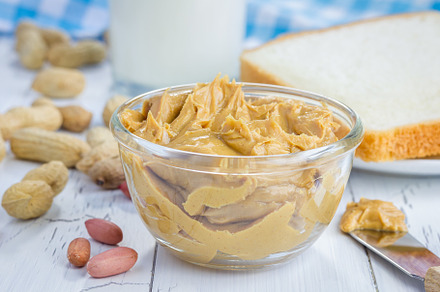 Creamy peanut butter with nuts and glass of milk, a Food & Drink Photo by iuliia_n