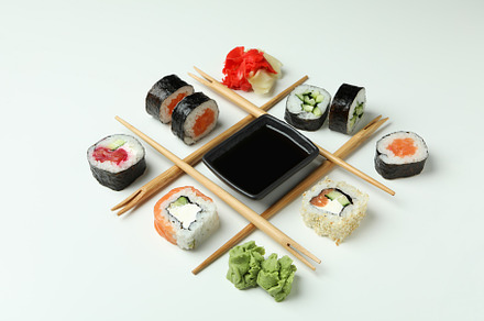 Concept of tasty food with sushi on white background, a Food & Drink Photo by AtlasStudio
