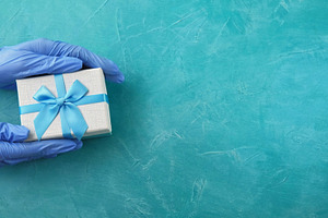 Gift delivery pandemic holidays hand glove box, a Person Photo by Photo Drive Studio