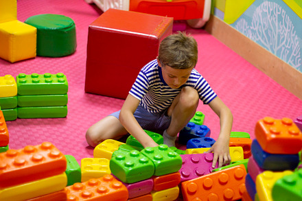 boy playing with building toy blocks