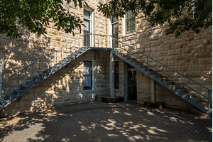 Dual metal staircases in courtyard, an Architecture Photo by Backyard Stock