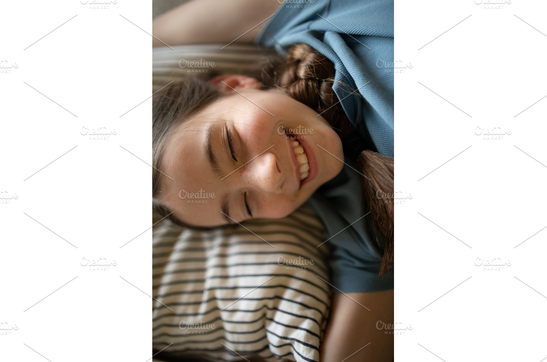Teenage girl lying on pillow with, a Person Photo by HalfPoint