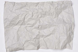 Smoothed crumpled sheet of grid paper with creases and texture o