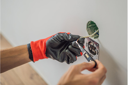 Master electrician installs a socket, an Industrial Photo by Elizaveta Galitskaya