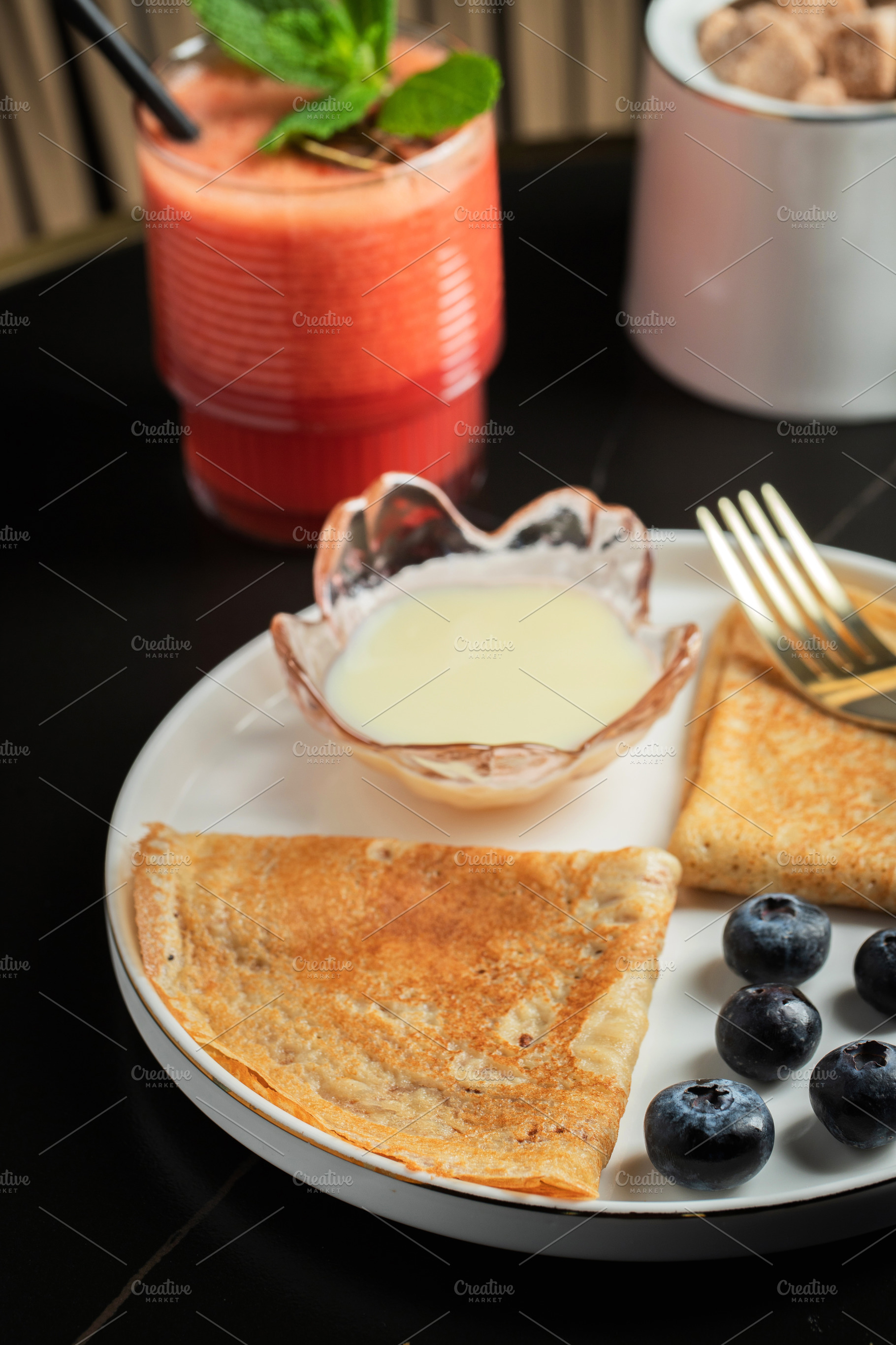 Pancakes with blueberry and honey on a white plate, a Food & Drink Photo by Budarinphoto