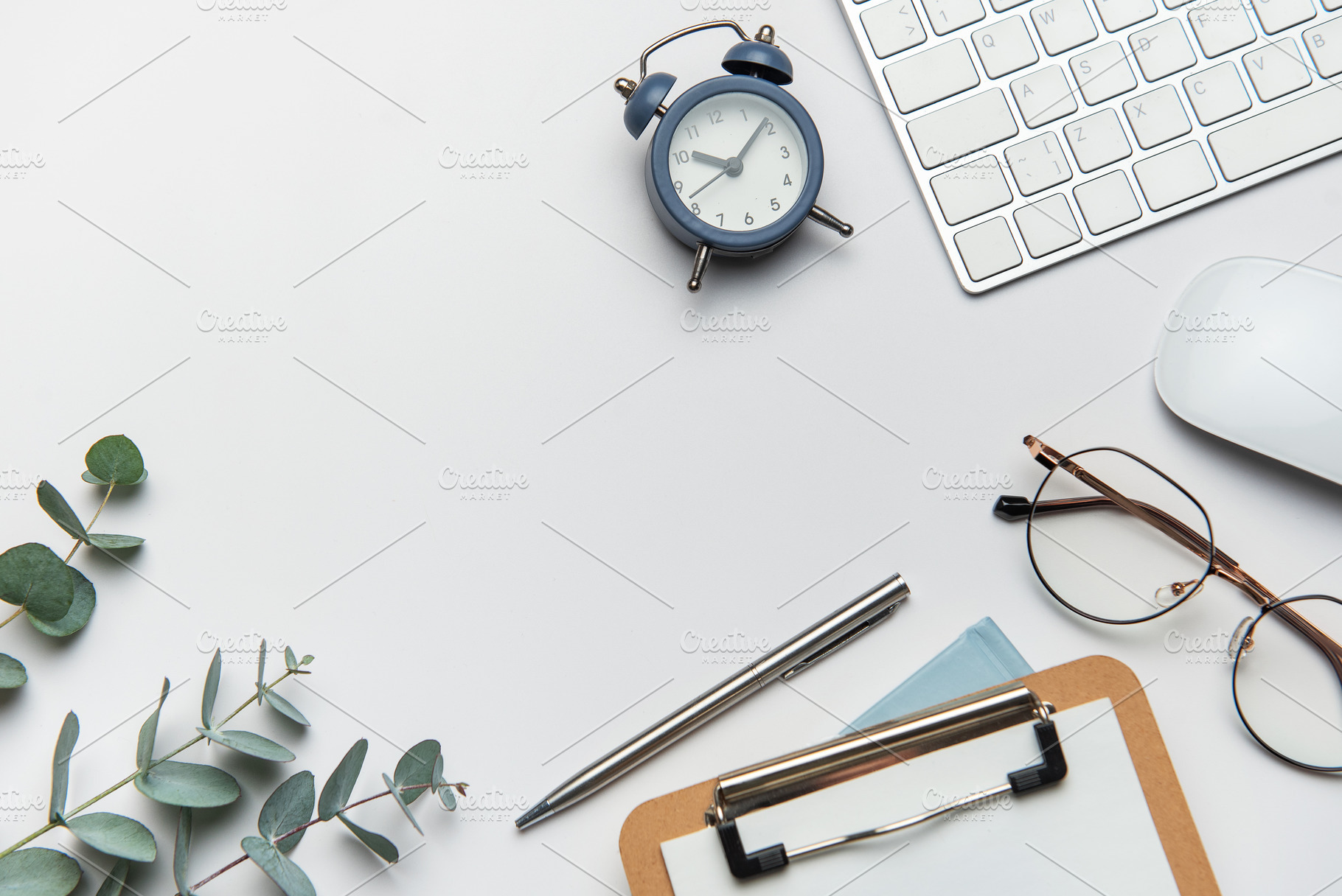 Workspace organizing eucalyptus branches, keyboard, mouse, alarm, a Business Photo by Olena Rudo