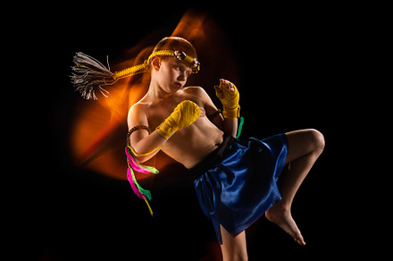 Little boy exercising thai boxing on black background. Fighter practicing, trai, a Sports & Recreation Photo by Volodymyr Melnyk