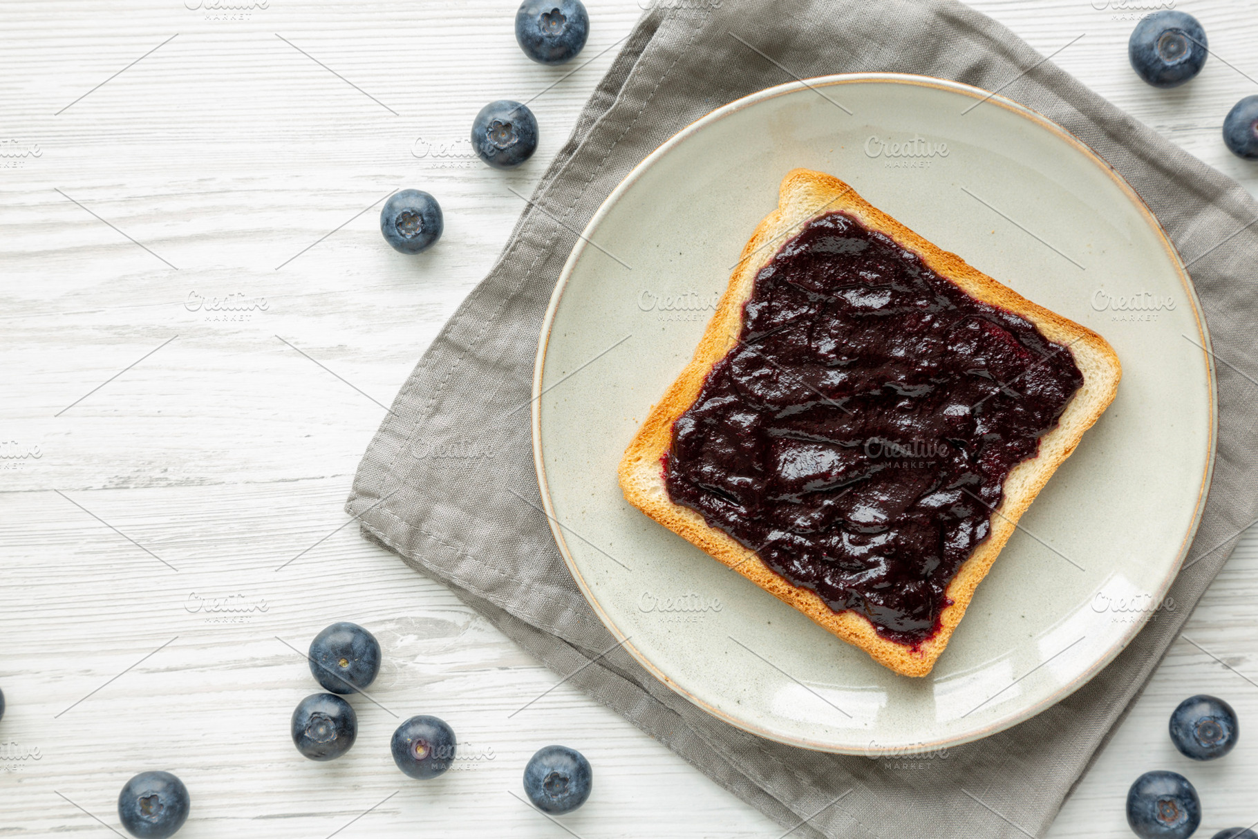 Healthy Blueberry Jelly and Toast on a Plate, top view., a Food & Drink Photo by LiudmylaChuhunova