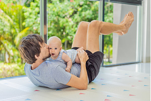 Father exercising with his small, a Person Photo by Elizaveta Galitskaya