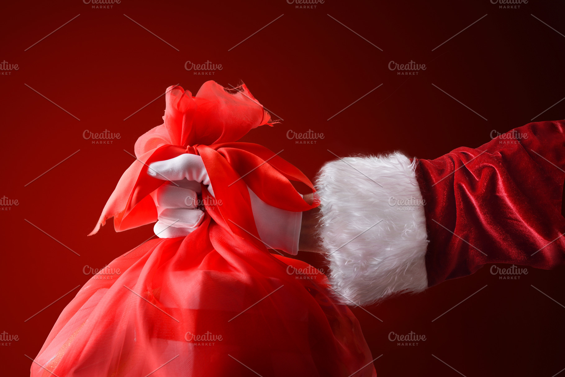 Santa's hand with a bag of gifts isolated background, a Person Photo by Davizro's Market