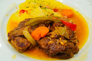 Braised meat with vegetables and potatoes on white plate, a Food & Drink Photo by DanFLCreativo