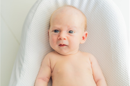 Adorable baby lying safely in a cozy, a Person Photo by Elizaveta Galitskaya