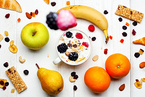 Healthy breakfast with yogurt, muesli, fresh and dried fruit falling in a cup, a Food & Drink Photo by Antonio Gravante Market