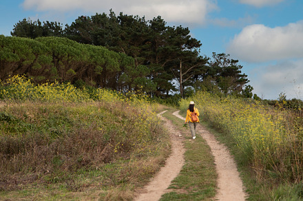Adult woman with a leather backpack walks down, a Person Photo by José Manuel Gelpi