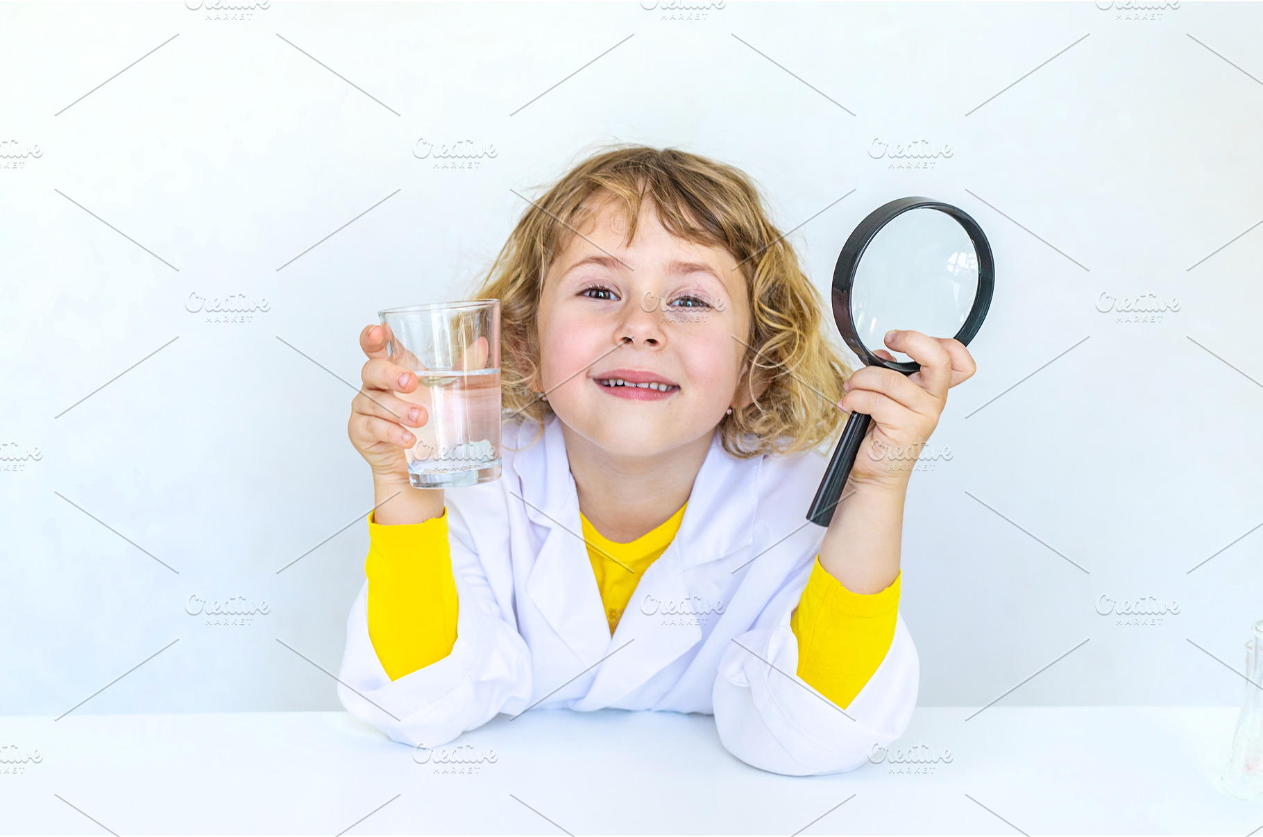 A child examines water with a, a School & Education Photo by yanadjana