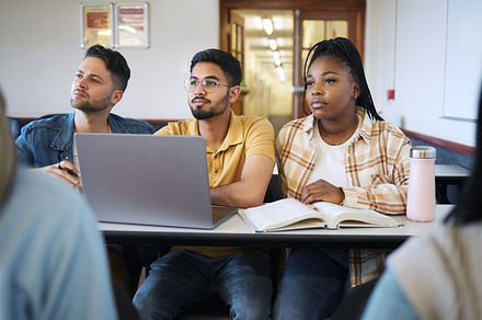 Students, diversity or laptop in school classroom, lecture or lesson on college, university or education campus. Men, black woman or study people with technology, research textbooks or learning goals, a Photo by Peopleimages.com