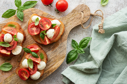 Bruschetta with tomato, basil and mozzarella cheese, a Food & Drink Photo by Olena Rudo