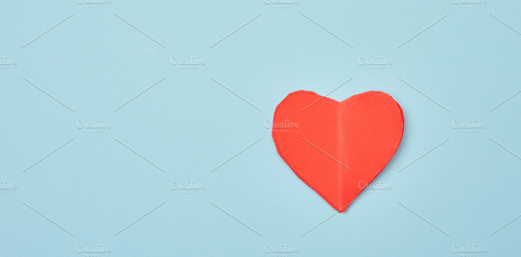Red paper heart on a soft blue background, minimalist compositio, a Holiday Photo by ndanko