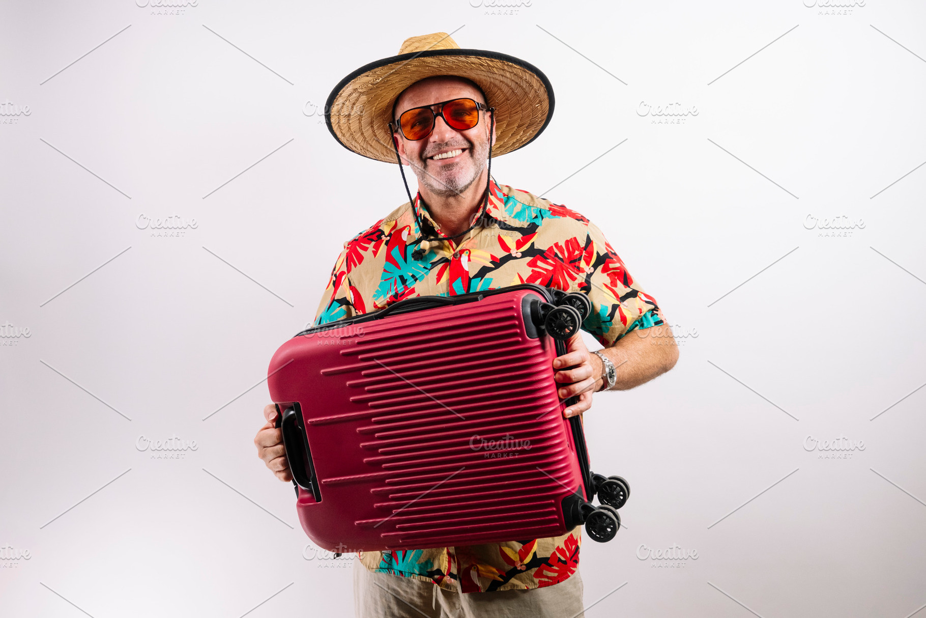 Tourist with red suitcase smiling, a Holiday Photo by karrastock