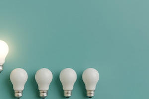 Lightbulb standing out from unlit bu, a Photo by Dvoevnore photos