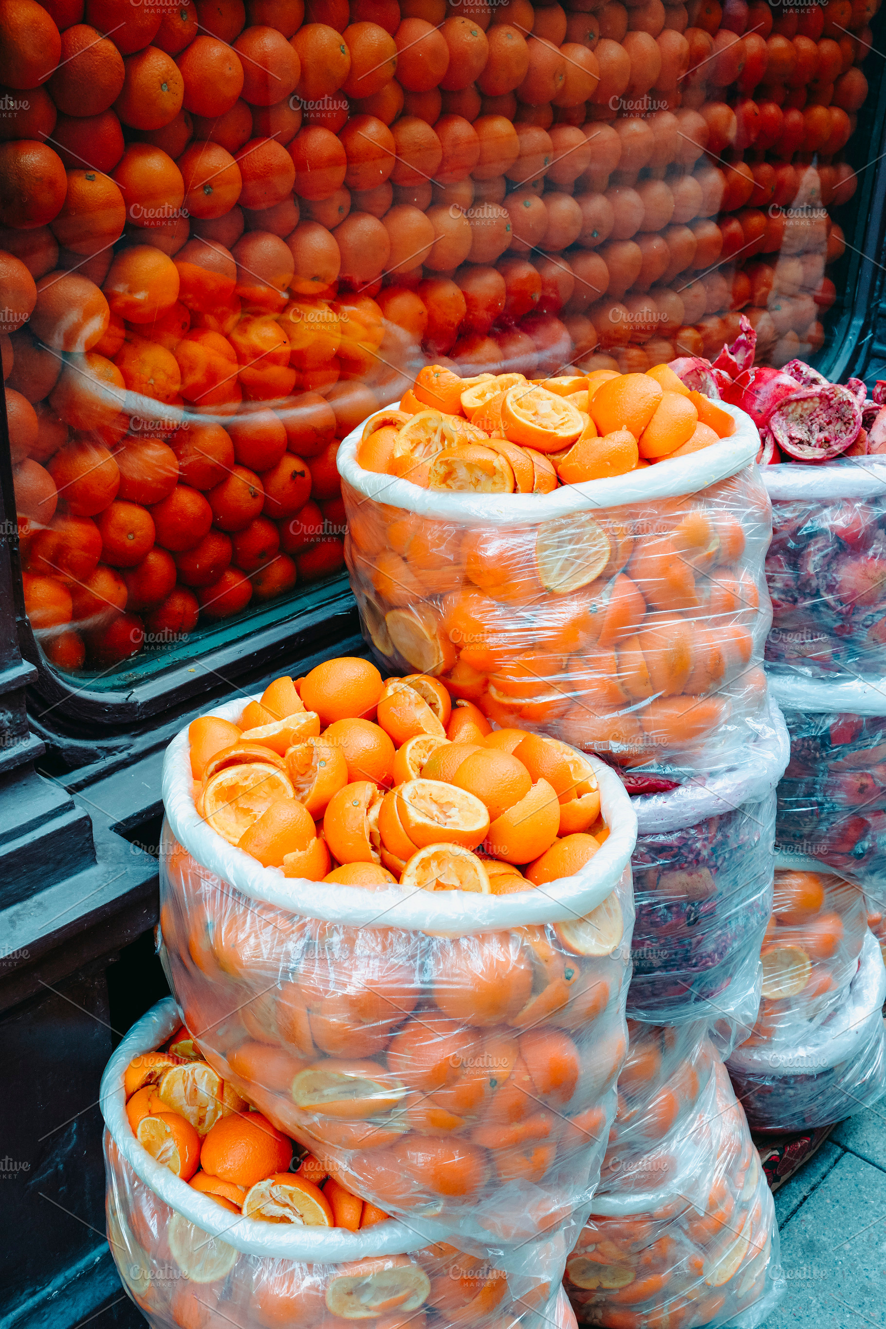 plastic bags filled with squeezed orange halves, a Photo by Nito