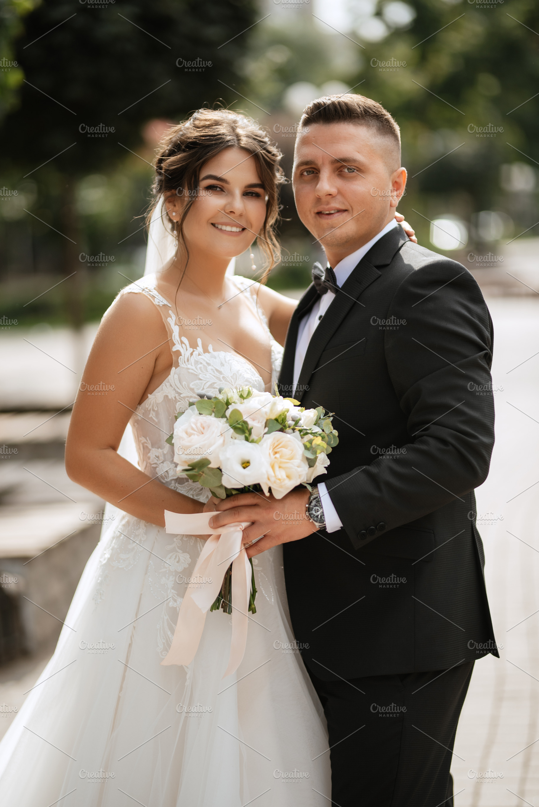 the groom in a brown suit and the bride in a white dress, a Person Photo by Weddings, People, Travel