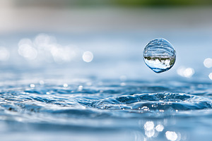 Water droplet hovering above the, a Background Photo by MistyDay