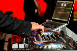 Disc jockey in elegant suit mixes mu