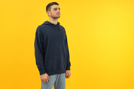 Young man in hoodie on yellow background, space for text, a Person Photo by AtlasStudio PRO