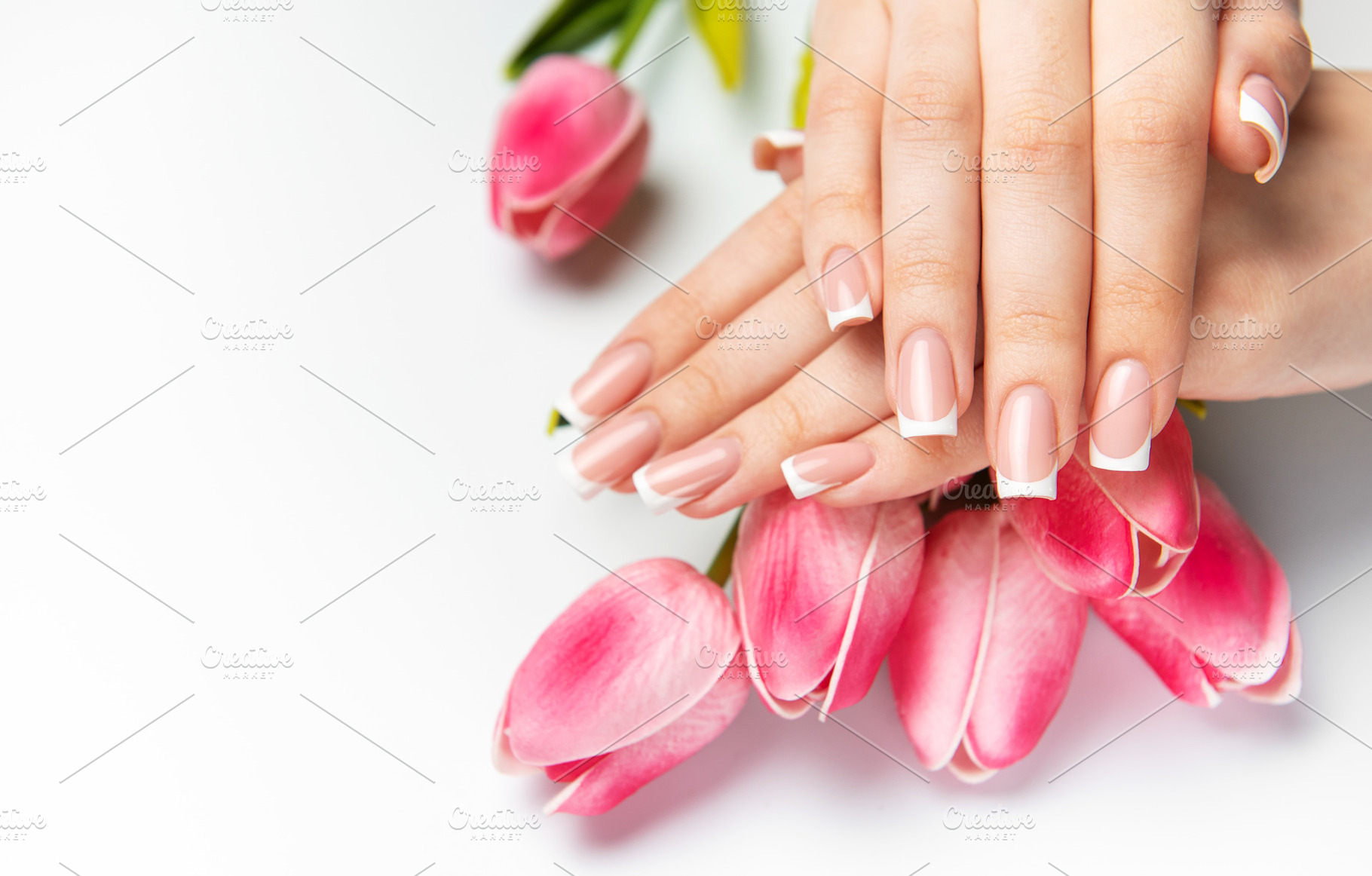 Woman showing french manicure and pink tulips on white backgroun, a Beauty & Fashion Photo by Olena Rudo