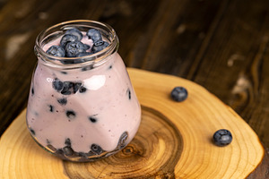 a glass jar with natural sweet blueberries and milk blueberry yogurt, a Photo by rsoollAI