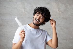 Home care after shower, morning routine procedure. Cheerful indian man with com, a Person Photo by Prostock-Studio