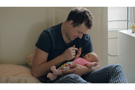 Man is happy to have a baby daughter, a Person Photo by Grey Coast Media