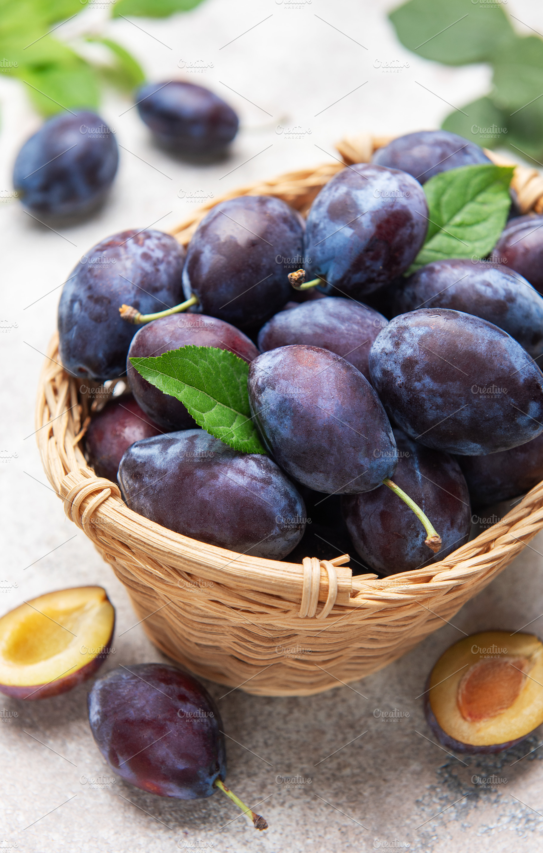 Fresh plums in wicker basket, healthy eating concept, a Food & Drink Photo by Olena Rudo