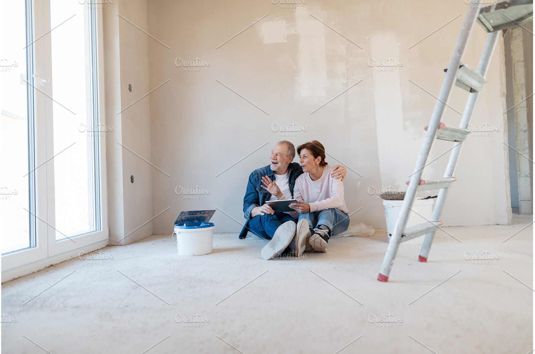 Senior couple renovating their home, a Person Photo by HalfPoint