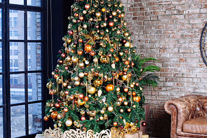 Interior with couch and decorated ch featuring ball, bauble, and bead