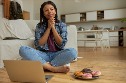 Portrait of thoughtful young Afro American woman blogger sitting barefooted on, a Person Photo by Anatoliy Karlyuk