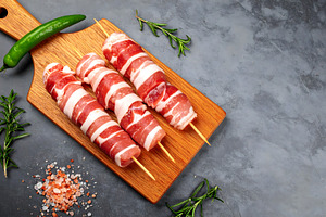 Bacon Wrapped Skewers on a Wooden Bo, a Food & Drink Photo by Stock Shape