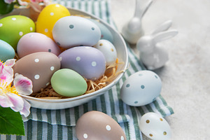 Pastel easter eggs in bowl with bunnies decoration, a Holiday Photo by Olena Rudo