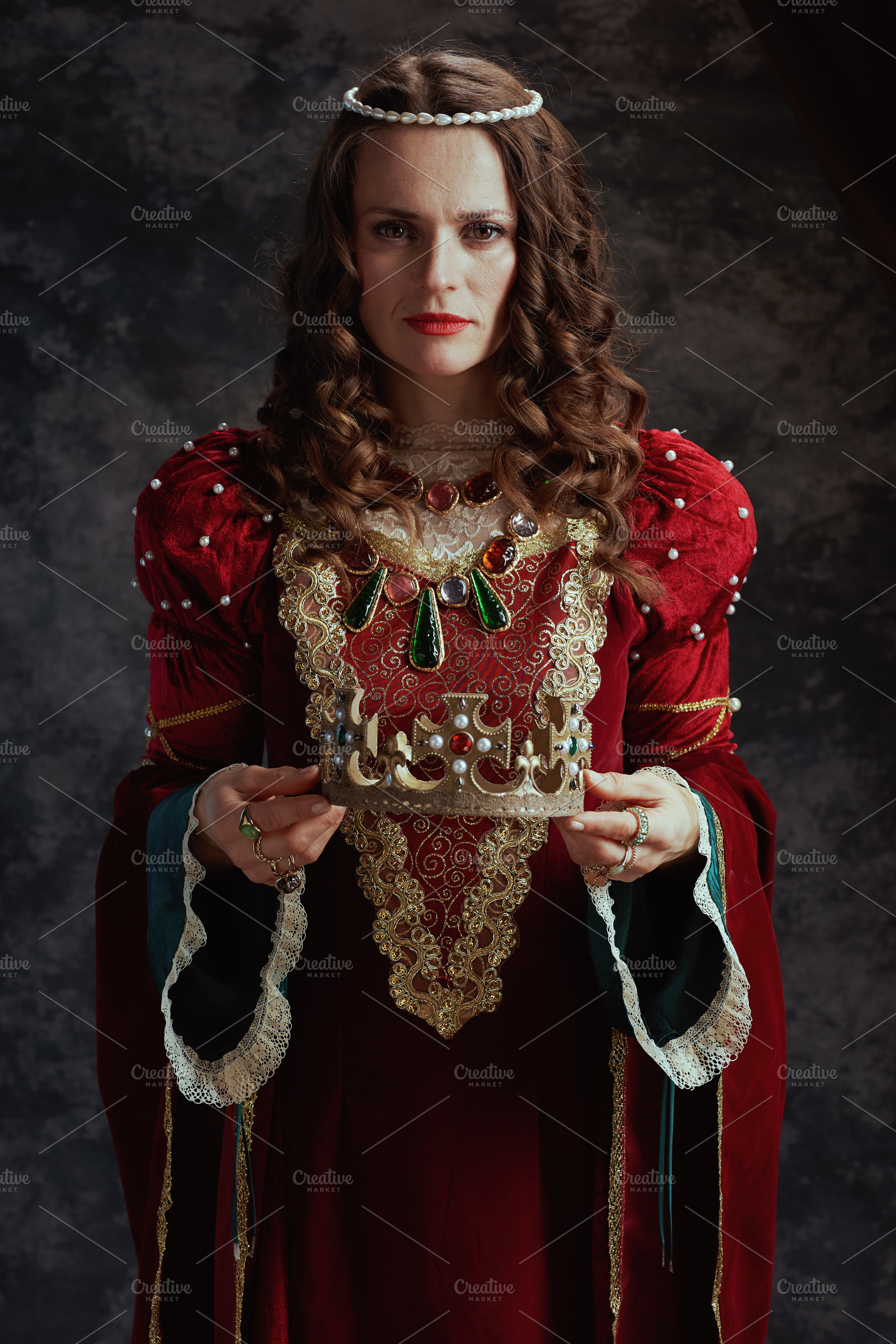 medieval queen in red dress with crown, a Person Photo by Alliance Images