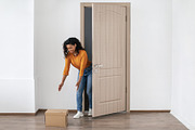 African Lady Receiving Box Standing Near Opened Door At Home, a Photo by Prostock-Studio (Thumbnail 2 of 2)