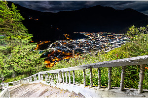 Illuminated city of Banos at night, Ecuador, an Architecture Photo by Leonid Andronov