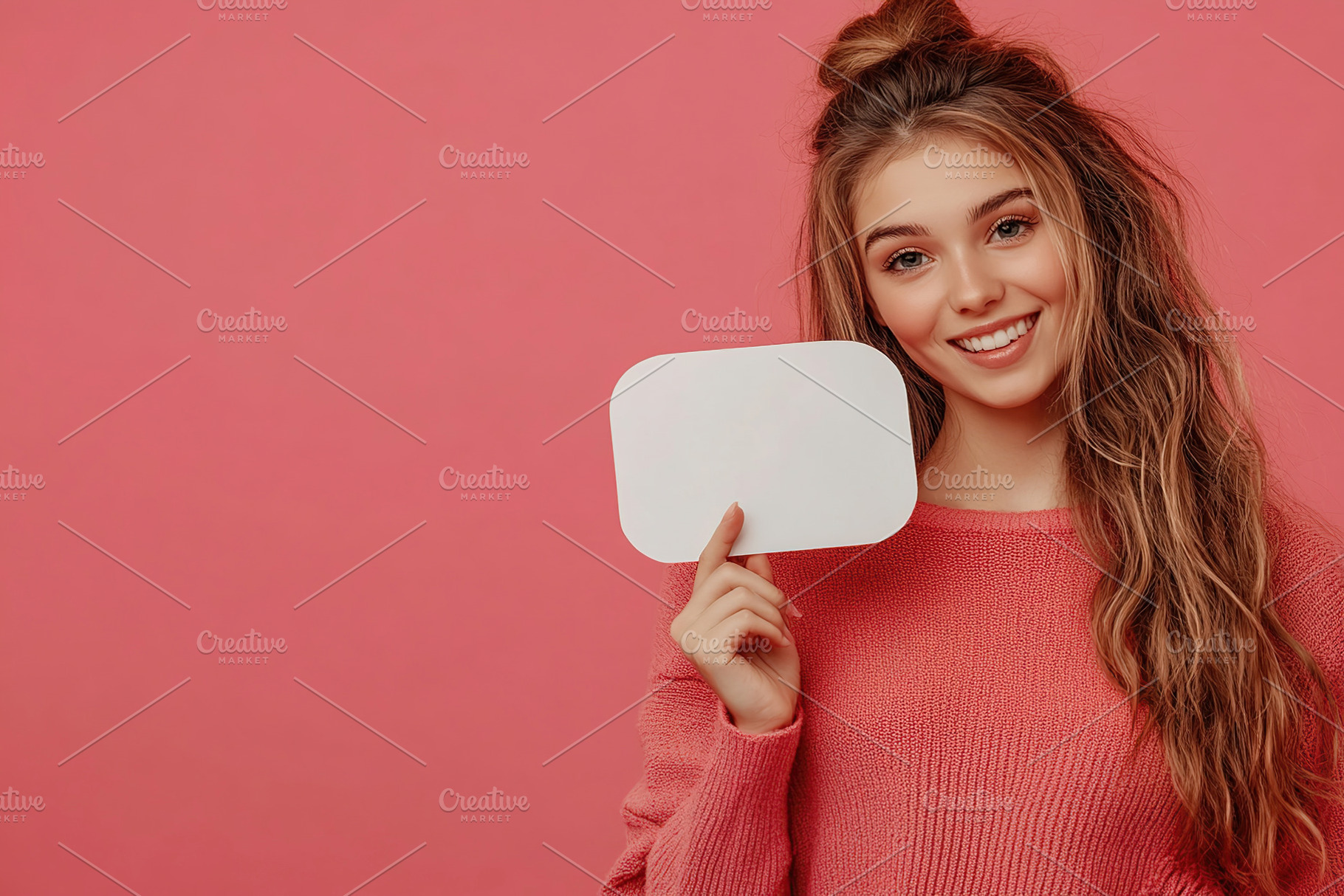 Smiling young woman holding a blank sign against a pink background, a Person Photo by AlyaAnd