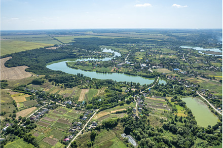 Aerial view of town with river and, a Nature Photo by Yaroslav Danylchenko