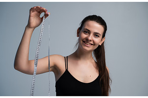Young woman smiling and holding a, a Sports & Recreation Photo by volodymyrshtun13795