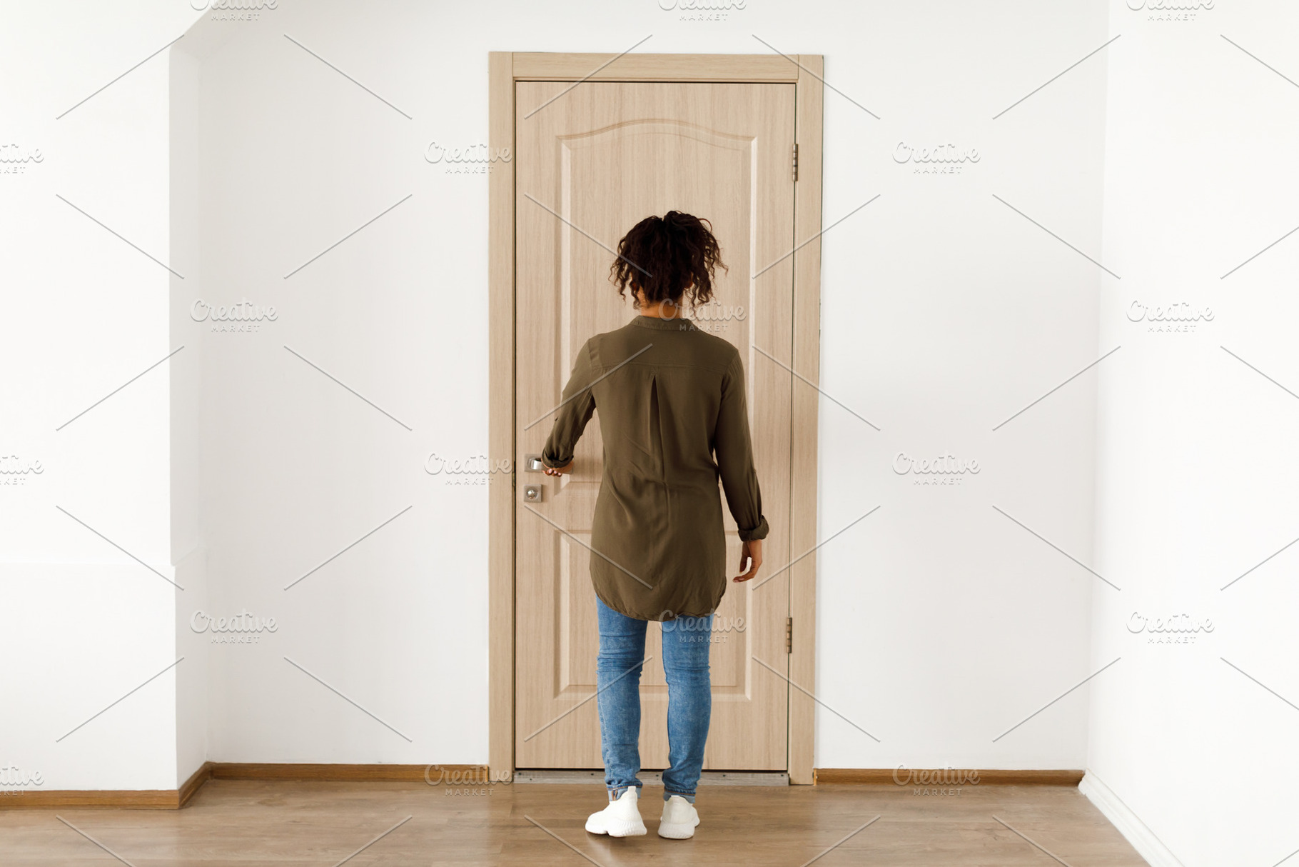 Back View Of Black Female Opening Apartment Door Standing Indoor, a Photo by Prostock-Studio