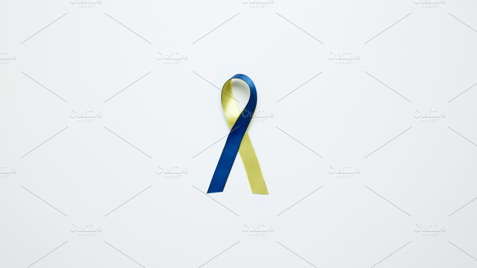 Symbolizing World Down Syndrome Day. A yellow and blue awareness ribbon, a Photo by matucha