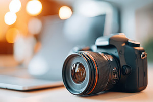 Professional camera on a wooden table, a Technology Photo by AlyaAnd